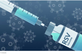 A needle withdraws the vaccine in an RSV vial.